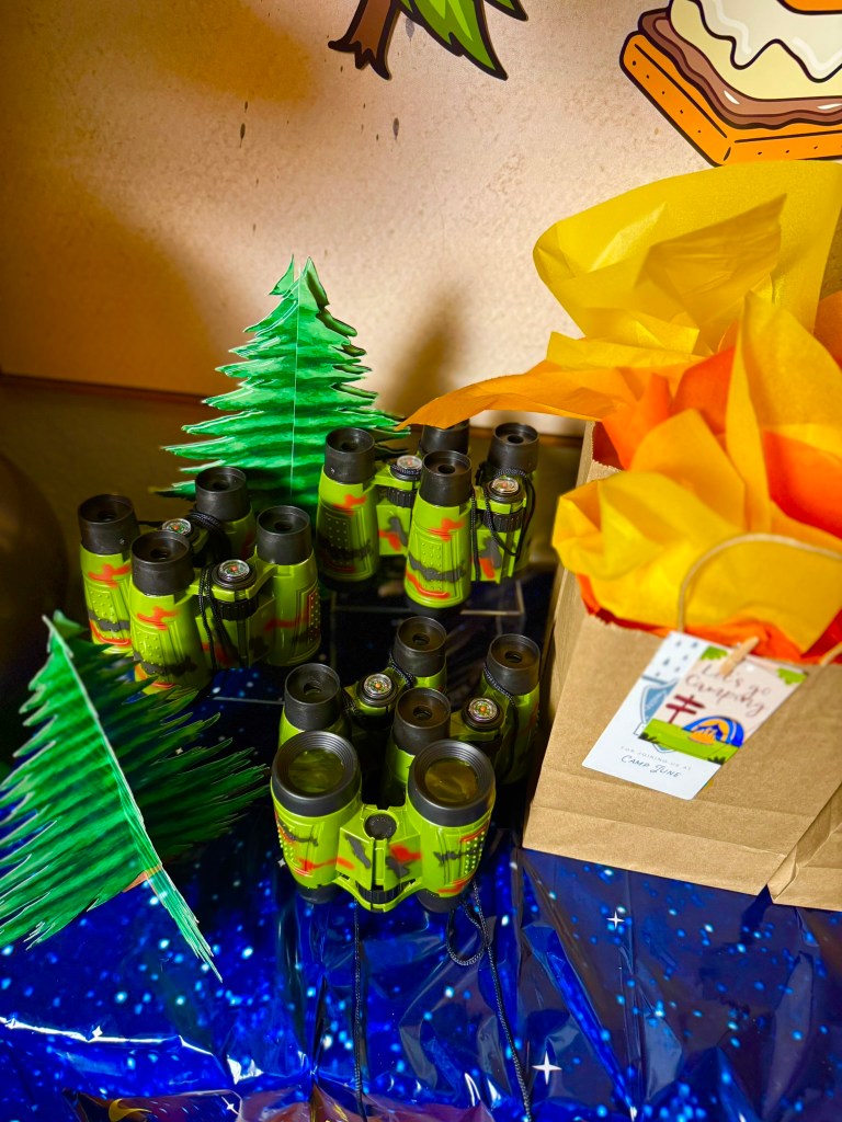 Toy binoculars used as camping party favors for a kids camping themed birthday party.