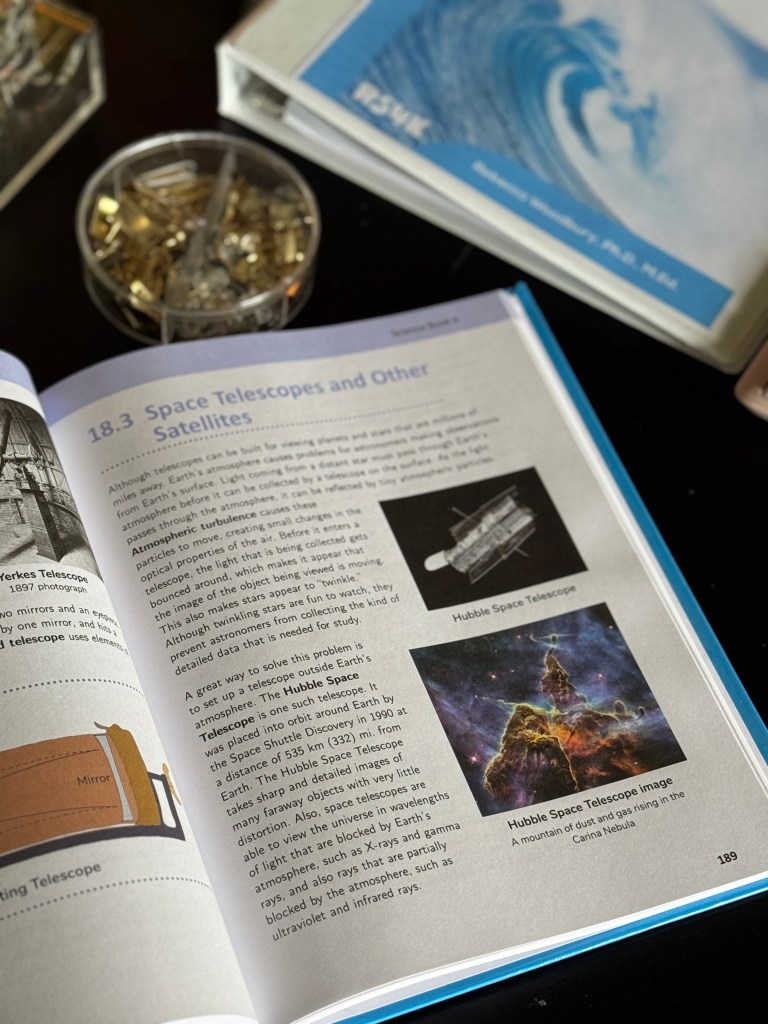 Open science textbook page featuring information about space telescopes, including illustrations of the Hubble Space Telescope and an image of the Carina Nebula.