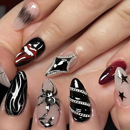 Close-up of intricately designed Halloween-themed nails featuring a mix of black, red, and nude colors, adorned with spider motifs, chains, and bold patterns.