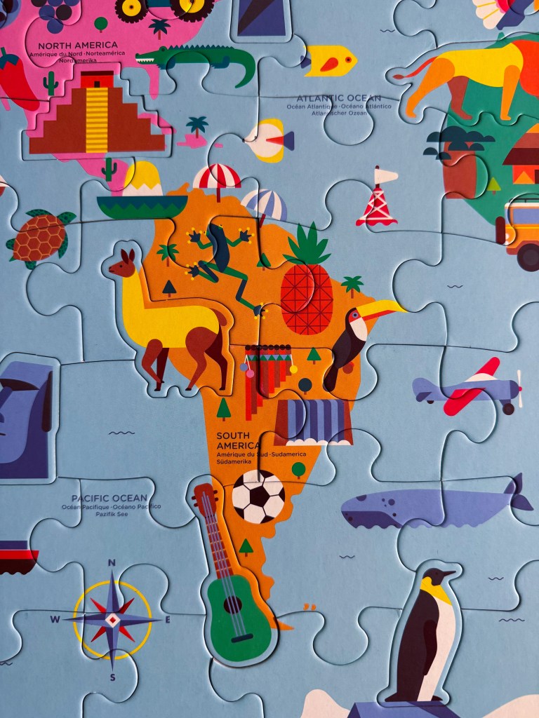 South America section of a world map puzzle featuring animals, landmarks and colorful illustrations.