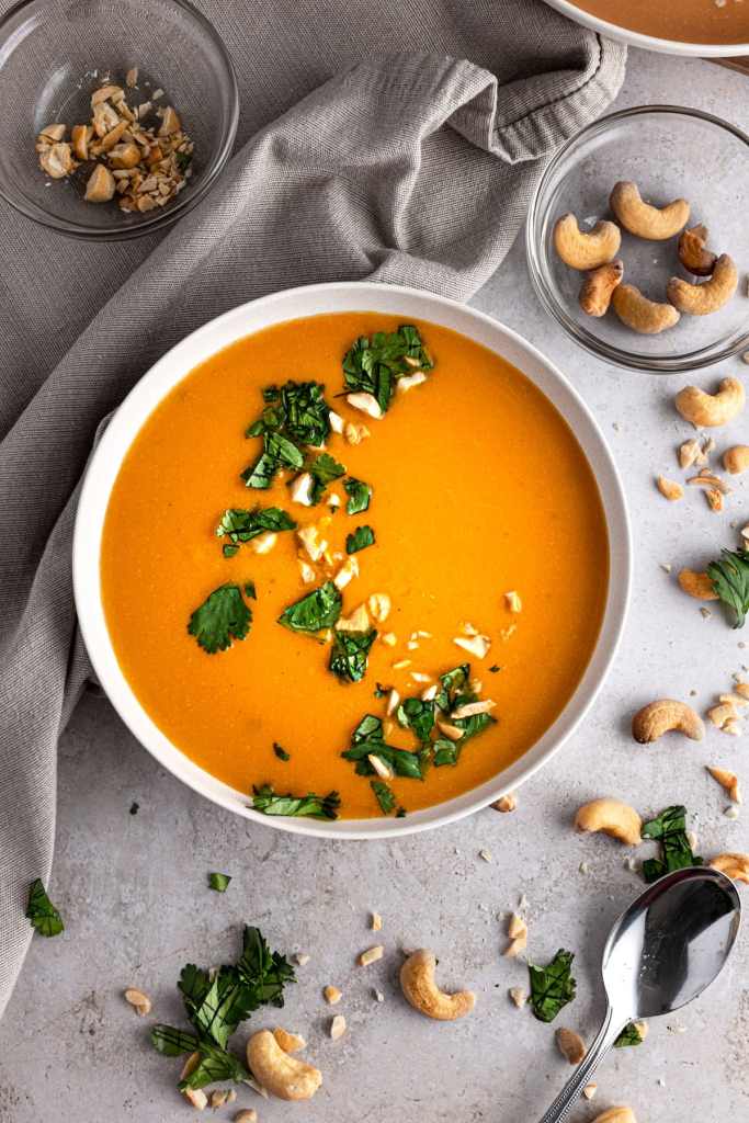 Cozy fall cashew ginger soup with warm spices and fresh cilantro garnish