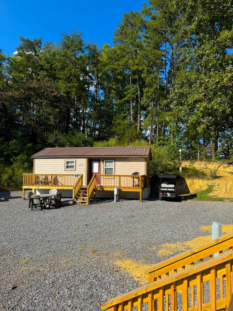 Exterior of a family cabin with wooden deck at Jellystone Park Pigeon Forge