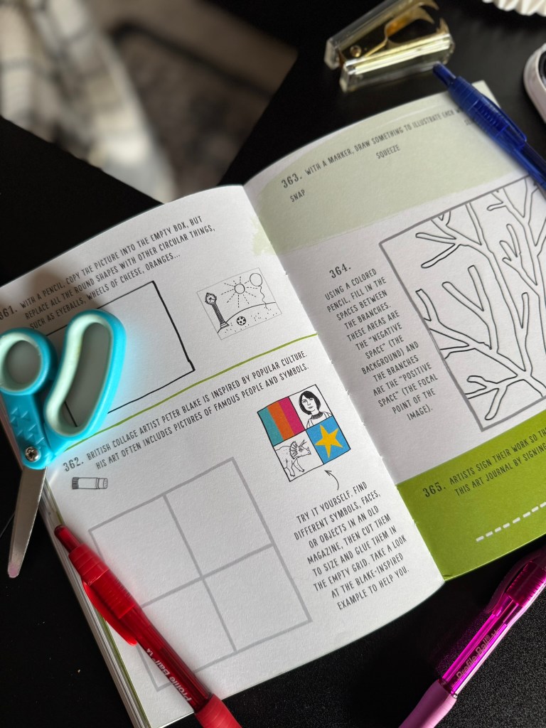 Opened pages of an art prompt book featuring drawing instructions and examples with colored pencils and scissors placed nearby.