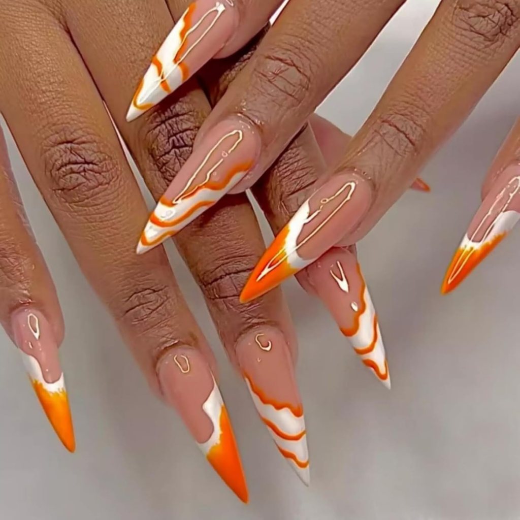 Long stiletto nails with orange and white swirl nail art design