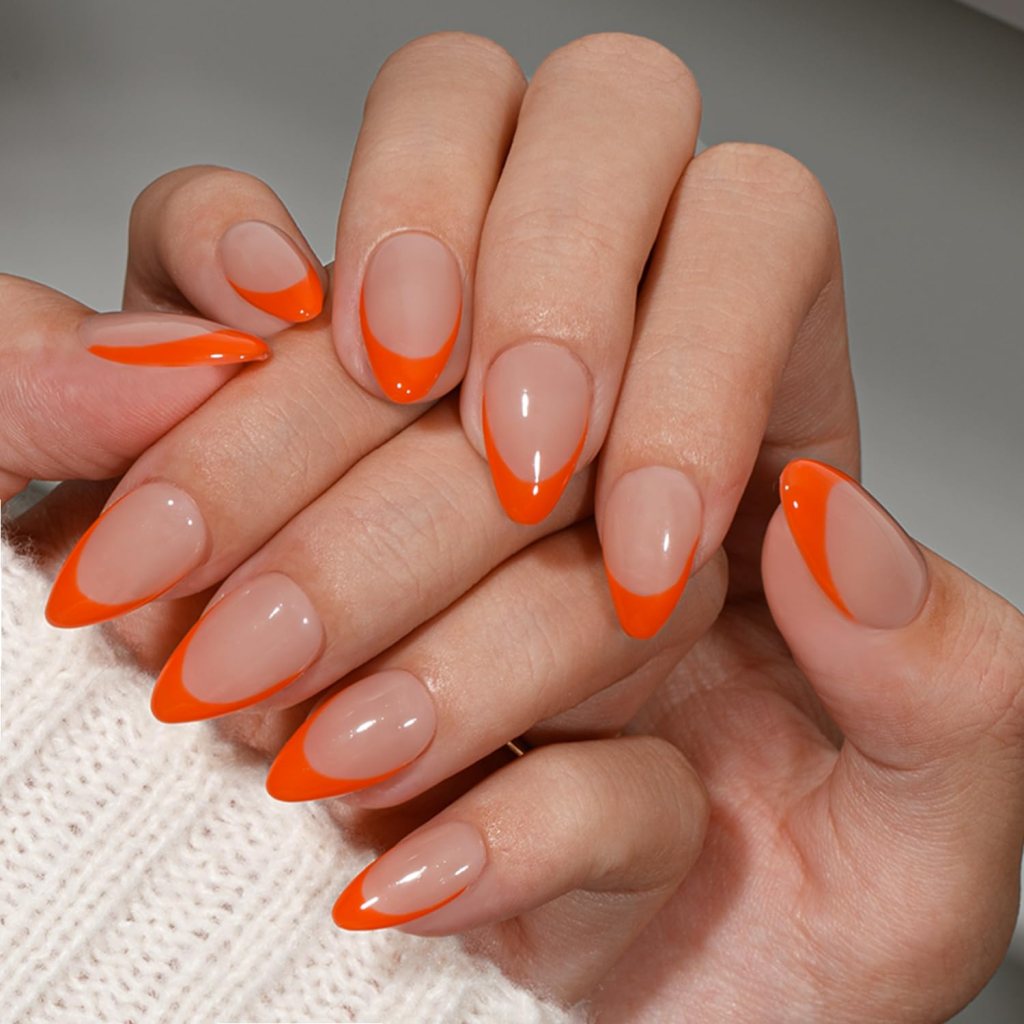 Almond nails with nude base and bright orange French tip design