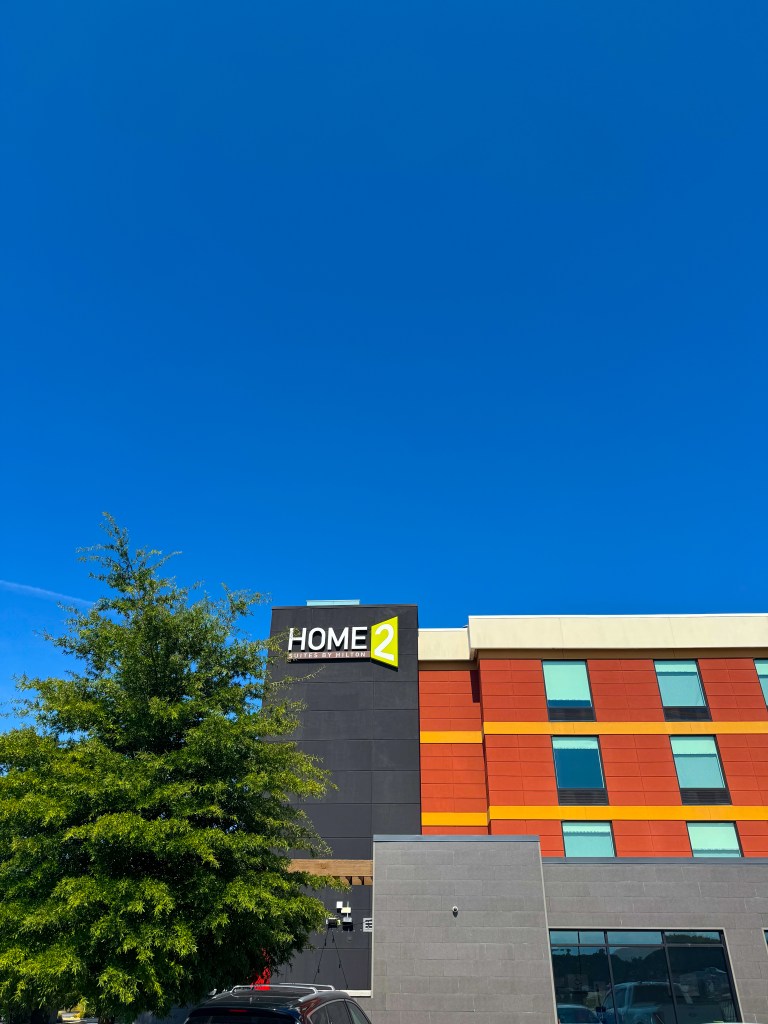 Colorful exterior of Home2 Suites by Hilton Pigeon Forge under a blue sky.