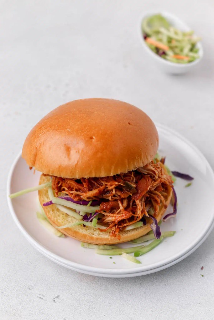 Pulled chicken sandwiches with barbecue sauce on soft buns for an easy summer cookout meal.