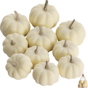 A collection of small white decorative pumpkins arranged together, showcasing various sizes and shapes, ideal for fall decor.