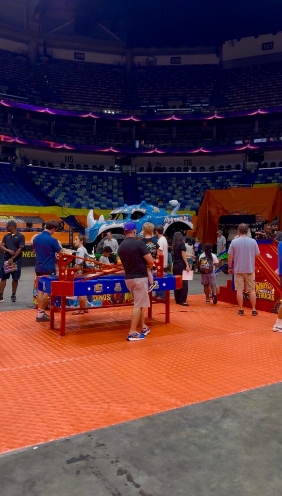 Families and children gathered around an activity table during the Hot Wheels preshow.
