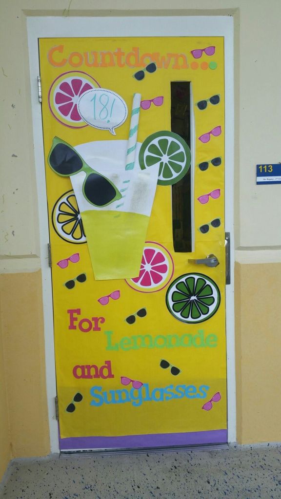 Decorative door design with a yellow background featuring a large lemonade cup, colorful fruit slices, and sunglasses, with text reading 'Countdown... 181 For Lemonade and Sunglasses'.