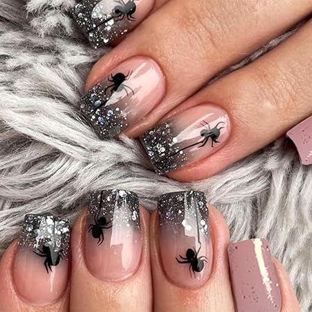 Nails featuring a gradient sparkle design with black spiders, creating a spooky aesthetic for Halloween.