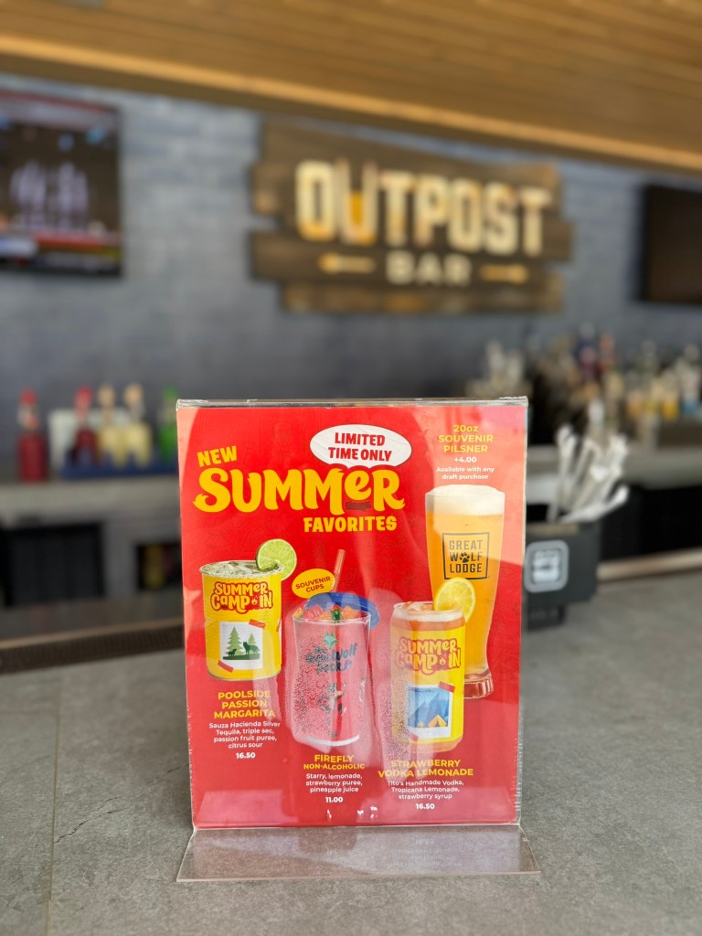 Outpost Bar area with Summer Camp In specialty drink menu on counter at Great Wolf Lodge in Grapevine, Texas