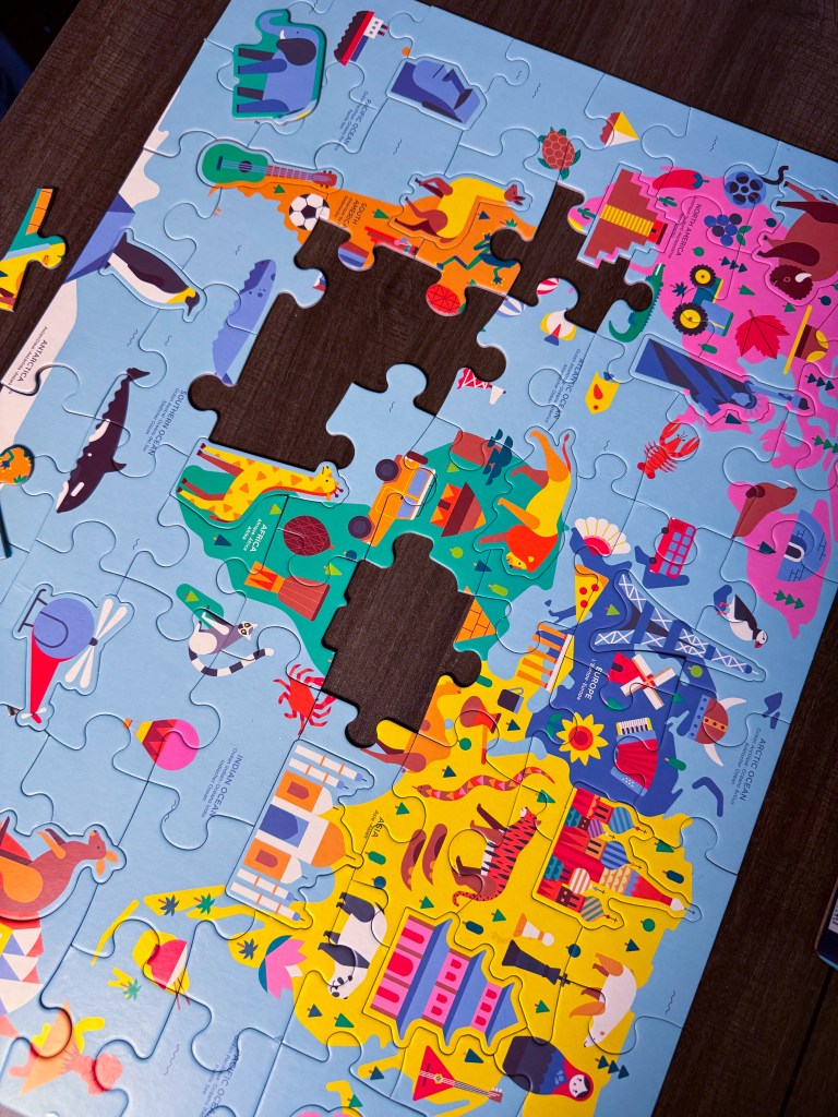 Close-up of the colorful Map of the World Geography Puzzle with several pieces still being placed.