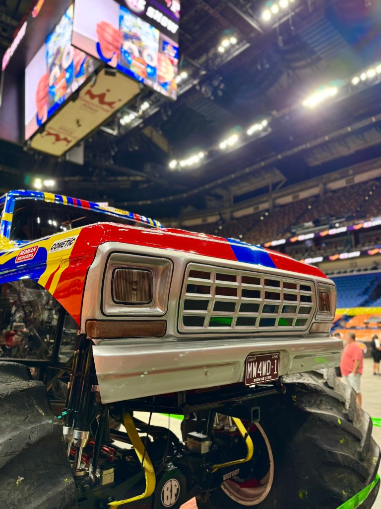 Blue, yellow and red Bigfoot monster truck displayed during the New Orleans preshow.