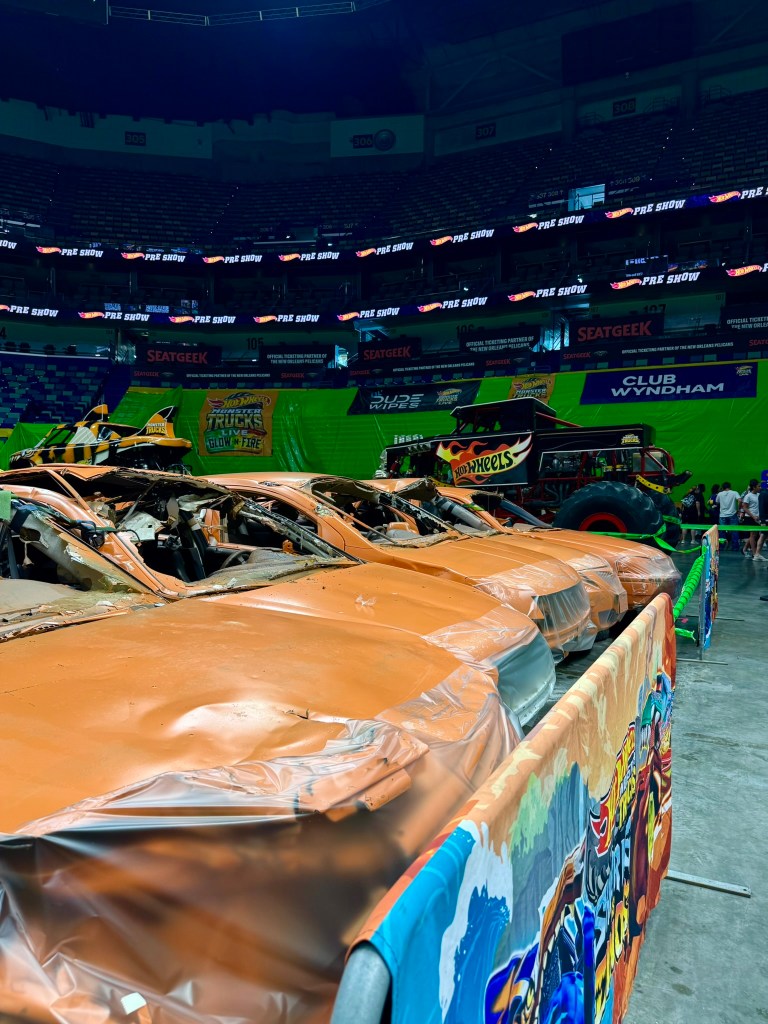 Rows of crushed cars arranged as obstacles on the Hot Wheels monster truck arena floor.