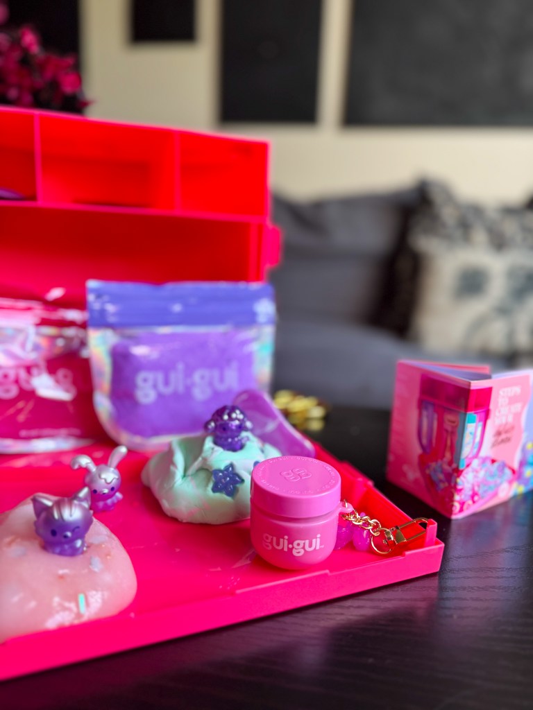 Gui Gui Mega Slime Haul open carrying case filled with different slimes, mini figures, tools and decorating accessories for tweens.