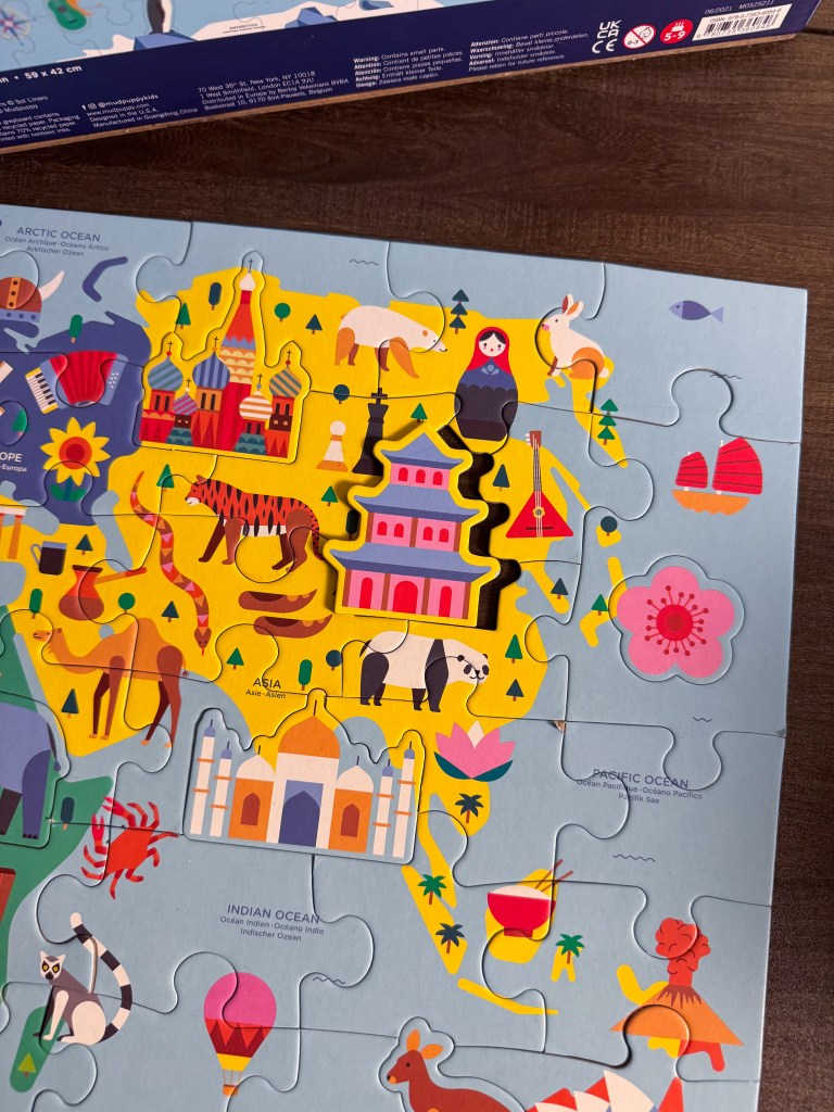 Landmark piece placed into the Asia section of the world map puzzle with other animals and landmarks visible.