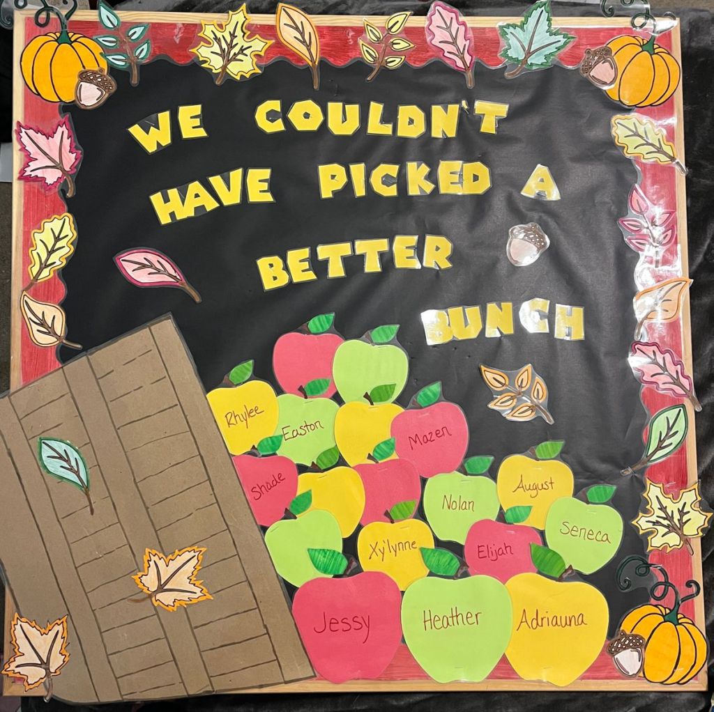 Fall apple bulletin board with colorful student name apples, autumn leaves, pumpkins and a We Couldn't Have Picked a Better Bunch message.