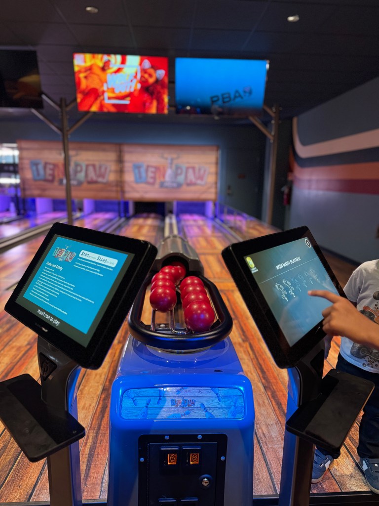 Child selecting players at the touchscreen for Ten Paw Alley mini bowling at Great Wolf Lodge Grapevine.