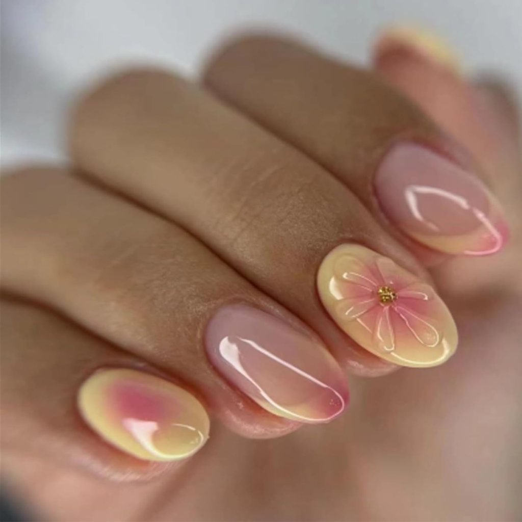 Butter yellow pastel floral short nails with delicate flower nail art and soft glossy manicure finish