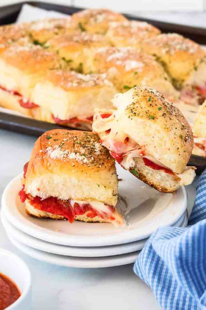 Pizza sliders on Hawaiian rolls with cheese, pepperoni, and pizza sauce for an easy family dinner.
