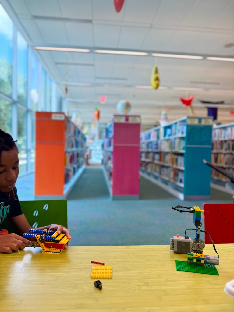 Student working through an iBrick engineering project at the library