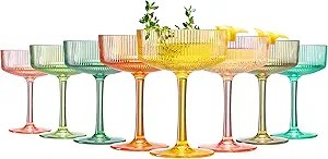 A collection of colorful, retro-inspired cocktail glasses in various pastel shades arranged in a row.