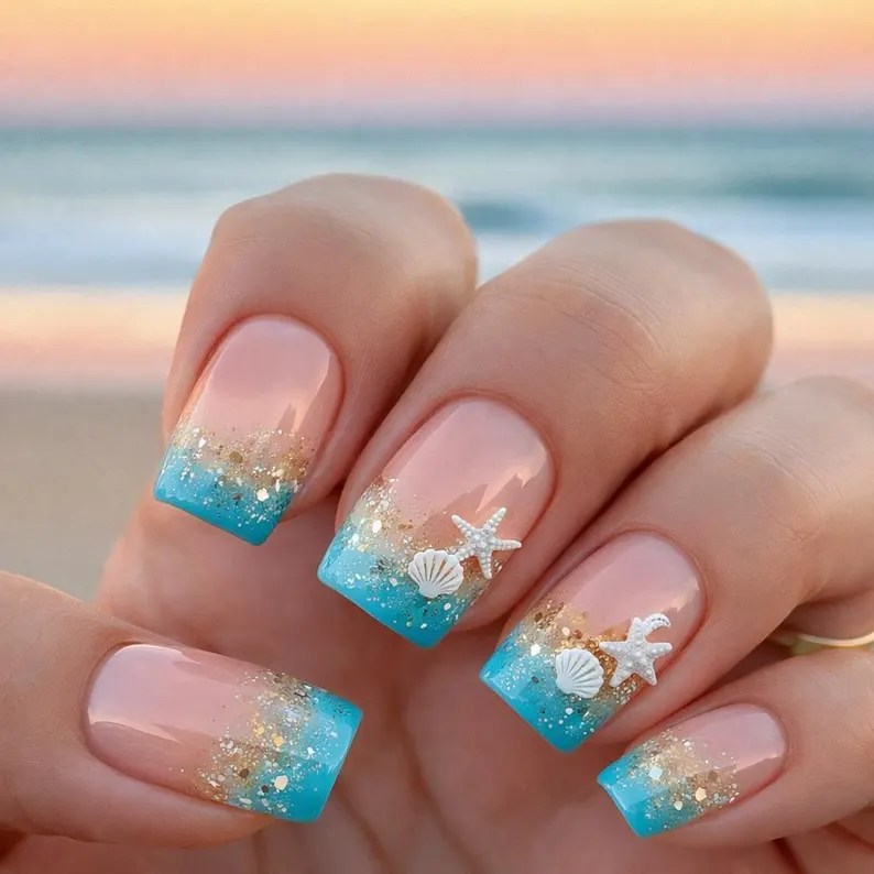 Glittery beach ocean nails with turquoise polish, seashell accents, and starfish nail art design