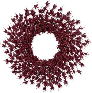 A maroon floral wreath made of intricate, small flowers arranged in a circular shape, perfect for seasonal decor.