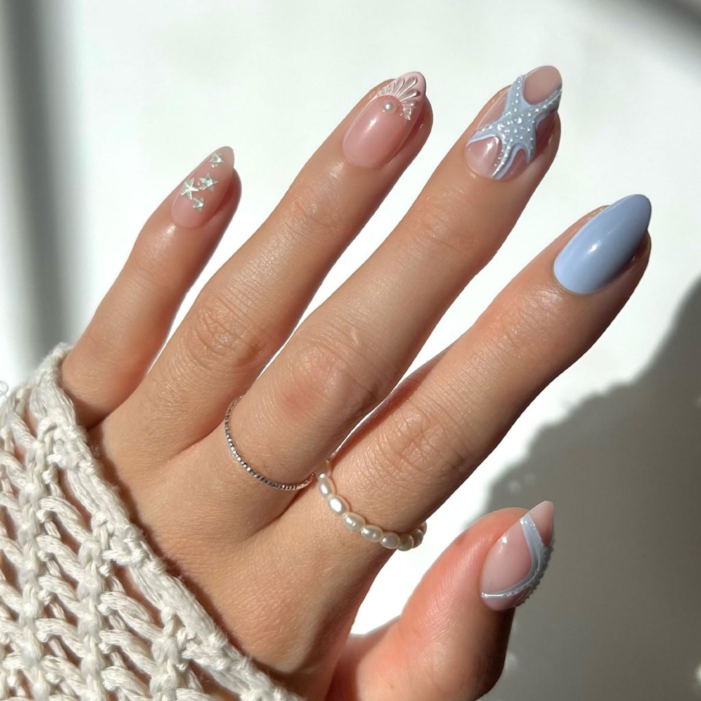 Soft blue starfish French tip ocean nails with pearl details and elegant coastal-inspired summer manicure