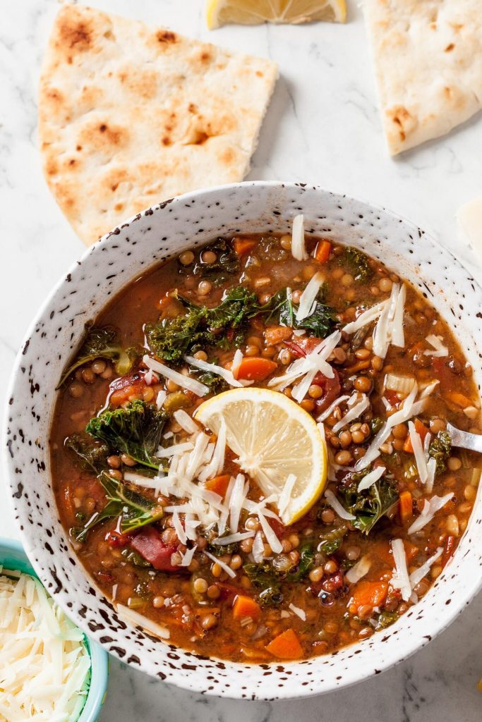 Homemade lentil soup with vegetables and warm spices in a ceramic bowl