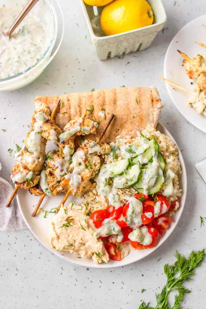 Greek chicken skewers with marinated grilled chicken and fresh dipping sauce for an easy summer dinner.
