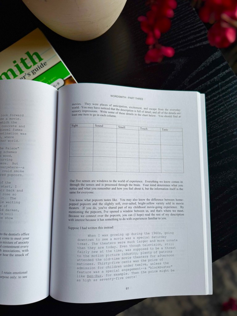 An open book page titled 'WORDSMITH - PART THREE' with instructions for describing sensory impressions related to movies. The page includes a chart with columns for sight, sound, smell, touch, and taste, along with text discussing the importance of sensory details.