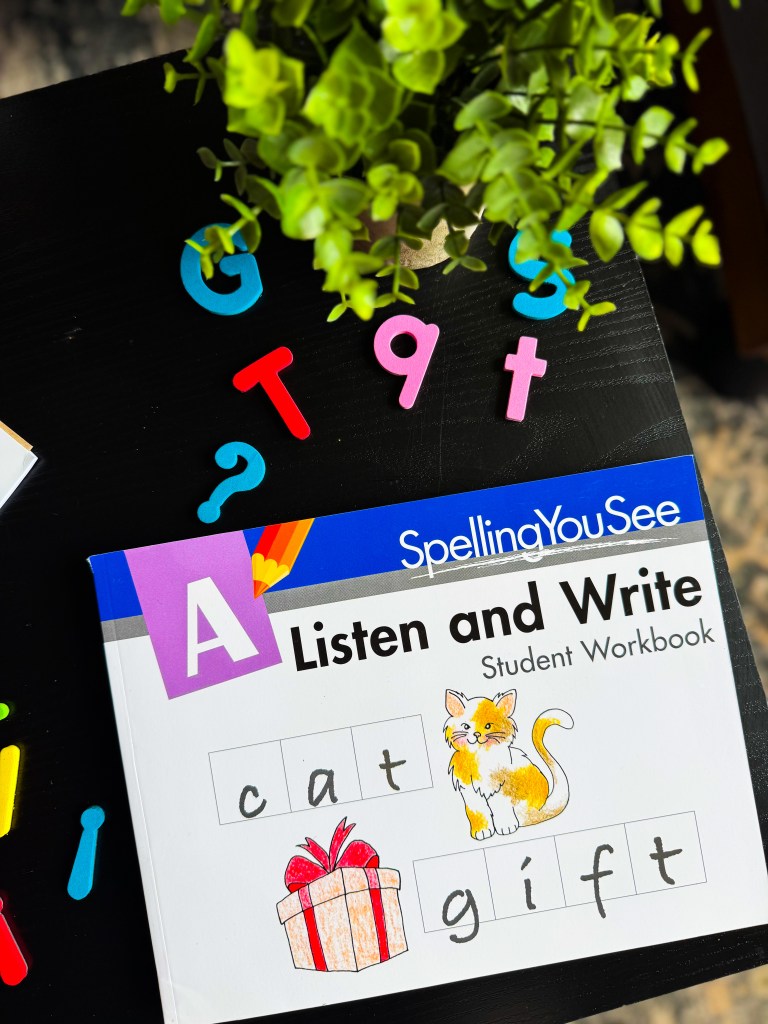 Spelling You See Level A student workbook cover featuring handwriting examples of the words cat and gift for beginner spelling practice.