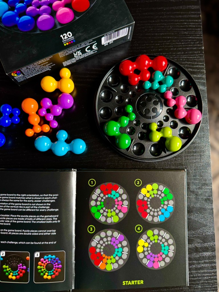 Hands-on view of a child solving an IQ Circle logic puzzle