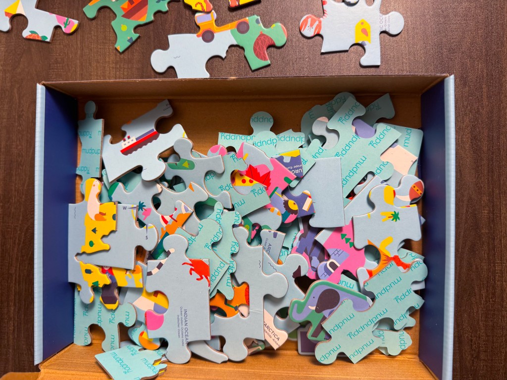Close-up of the colorful Map of the World Geography Puzzle with several pieces still being placed.